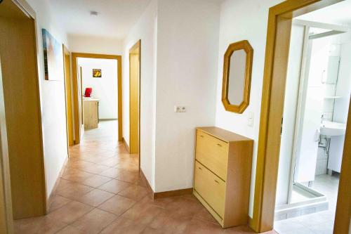 a hallway with a dresser and a mirror at Ferienwohnung Eller 79 in Vals