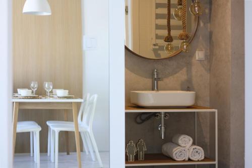 łazienka z umywalką i stołem z ręcznikami w obiekcie CHILLIapartamenty - Bliżej Morza - HYGGE w Kołobrzegu