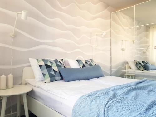 sypialnia z łóżkiem i ścianą w obiekcie CHILLIapartamenty - Bliżej Morza - HYGGE w Kołobrzegu