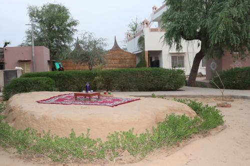 a table sitting on top of a circle in the sand at Desert Nights in Mandāwa