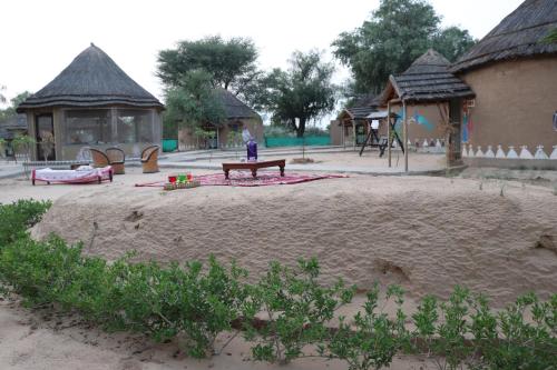a person sitting on a bench in a playground at Desert Nights in Mandāwa