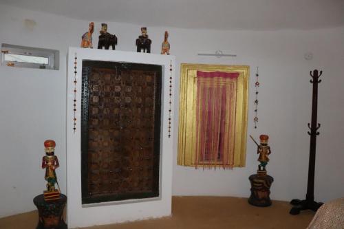 a room with a door and some figurines on top of it at Desert Nights in Mandāwa