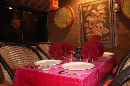 a table with a red table cloth on it at Desert Nights in Mandāwa