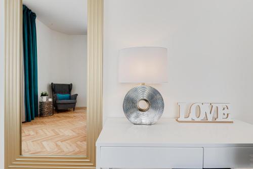 a mirror on a dresser in a living room at Gold Art Apartments in Prague