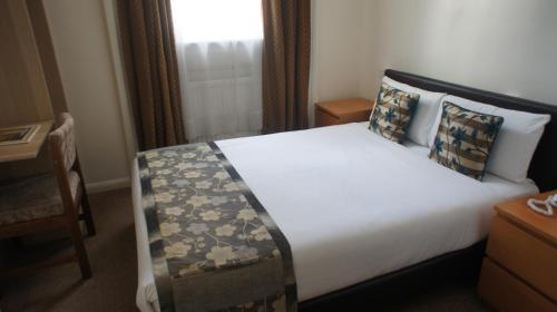 a hotel room with a large bed in a room at Westpoint Hotel in London