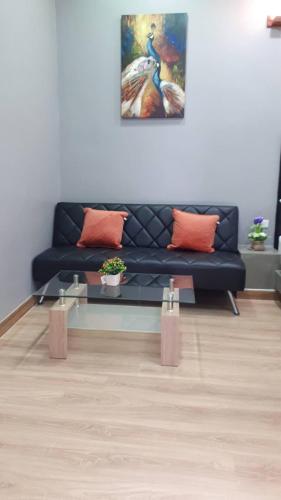 a living room with a blue couch and a table at Sawasdee​ Buriram​ Resort in Buriram