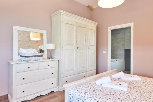 a bedroom with a white cabinet and a bed at Villa Celeste in Umag