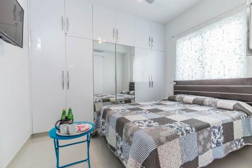 a bedroom with a bed and a blue table at Sea View apartment in Pyla
