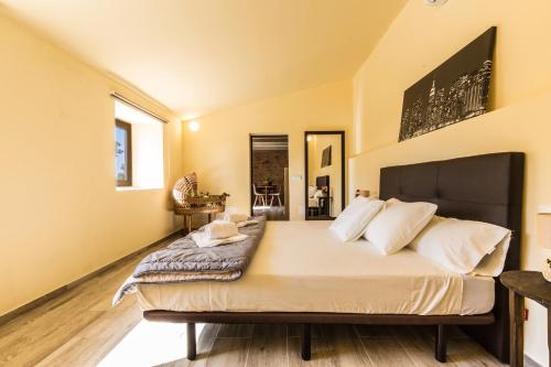 a bedroom with a large bed with white pillows at Finca Agroturismo Sa Cova den Borino in Campos