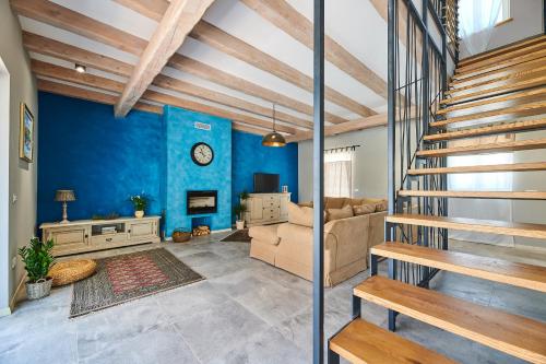 a living room with blue walls and a staircase at Villa Celeste in Umag