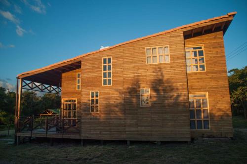 a large wooden house with a gambrel roof at Cabañas ecológicas Xuetama in Villa de Leyva