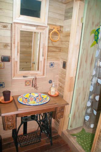 a small bathroom with a sink and a mirror at Cabañas ecológicas Xuetama in Villa de Leyva