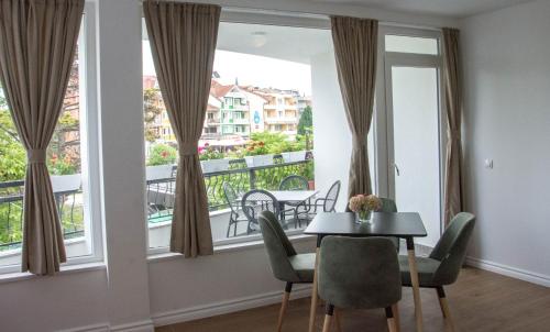 a dining room with a table and a large window at Seasons Hotel in Struga