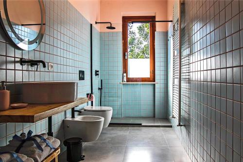 a bathroom with a toilet and a sink at House of Arts in Montelupo Fiorentino