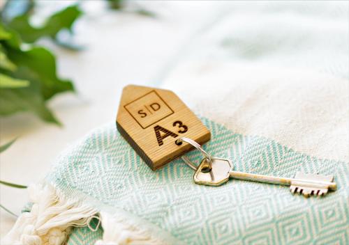 a small wooden toy with a key on a table at Sanidiamonds in Sani Beach