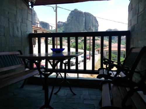 a table on a balcony with a view of a mountain at Kostis Hause in Kastrákion