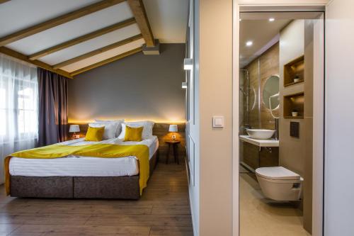 a hotel room with a bed and a bathroom at HillHouse Plovdiv in Plovdiv