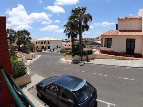 a black car parked on the side of a street at Refugio das Matas in Porto Santo