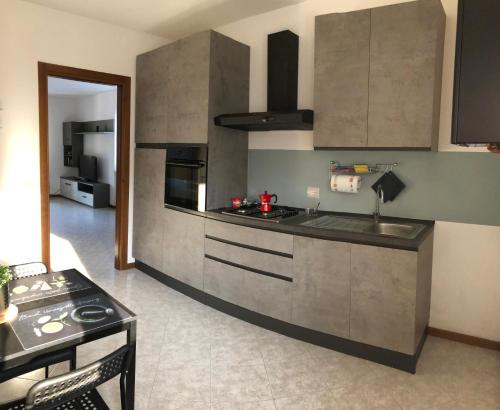 a kitchen with a sink and a stove top oven at La Terrazza di Beppe in Negrar