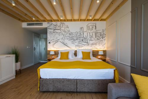 a bedroom with a large bed with a mural on the wall at HillHouse Plovdiv in Plovdiv