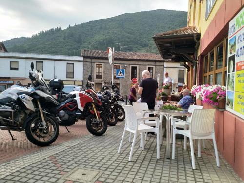 a group of motorcycles parked next to a table and chairs at Hosteria Picos De Europa in Potes