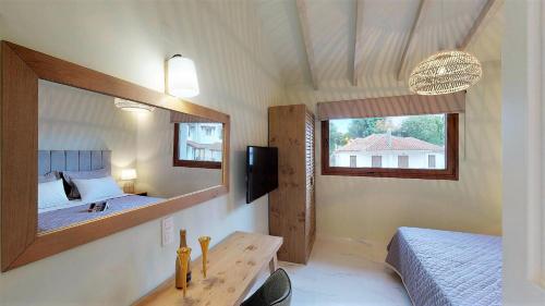 a bedroom with two beds and a mirror at Parga Inn Suites in Parga