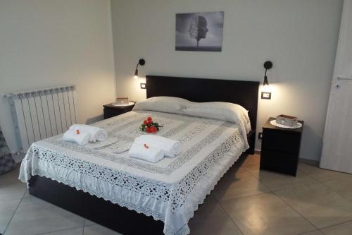 a bedroom with a bed with two white pillows at Cefalù Studio Room and Apartments in Cefalù