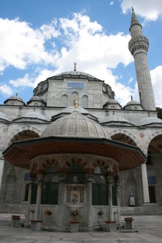 a large building with a mosque with a minaret at The Zanadu İstanbul in Istanbul