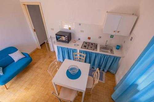 a small kitchen with a table and a sink at Sun & Sea, holidays home in Fontane Bianche
