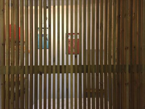 a wooden wall with a red object on it at Studio climatisé, La Cloison in Arles
