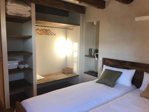 a bedroom with two beds and a closet at CAL PUIG, ENOTURISMO RURAL entre Viñas y Bosques in Juncosa