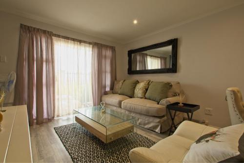 a living room with a couch and a coffee table at Modern Seaview Apartment in Summerstrand