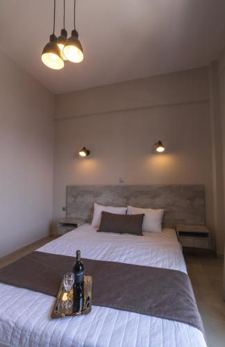 a bedroom with a large bed with a bottle of wine at Vivari Acta in Vivari