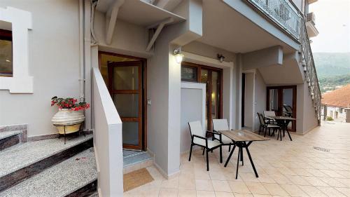a balcony of a house with a table and chairs at Parga Inn Suites in Parga