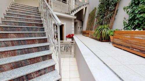 a set of stairs in a building with plants at Parga Inn Suites in Parga