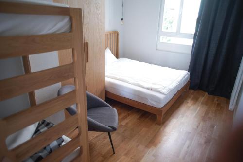 um pequeno quarto com um beliche e uma cadeira em Apartament Ludowa 4 Miedzyzdroje em Międzyzdroje