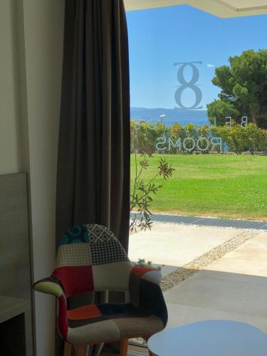 a chair sitting in front of a window at Bel Etage Luxury Rooms in Split