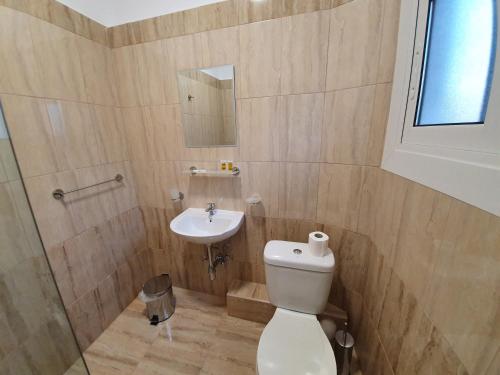 a bathroom with a toilet and a sink at City Centre Stylish rooms in Athens