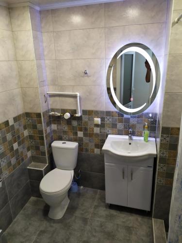 a bathroom with a toilet and a sink and a mirror at Apartment in Sevan