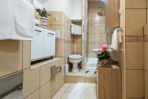 a small bathroom with a toilet and a sink at Rooftop city view apartment in the palace walls in Split