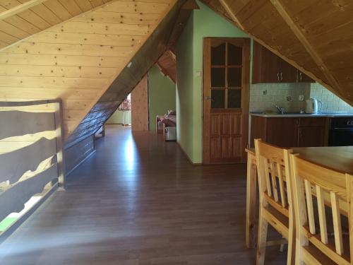 a kitchen and dining room with an attic at Mylak BIANCA in Korbielów