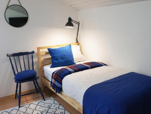 a bedroom with a bed and a chair and a lamp at RowerowyFun in Nowy Sącz