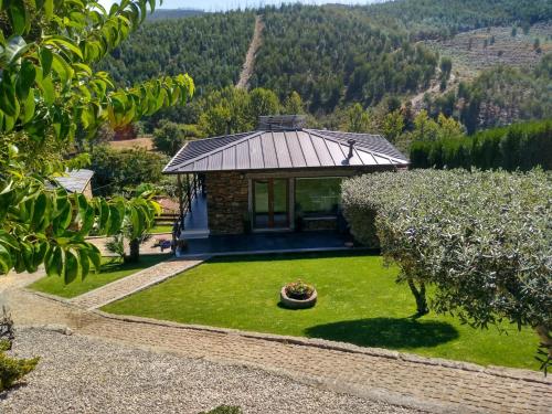 an aerial view of a small house with a garden at Canastro Country House in Castelo de Paiva