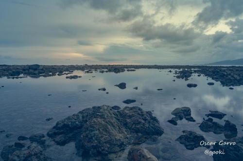 a large body of water with rocks in the water at Uvita Paradise in Uvita
