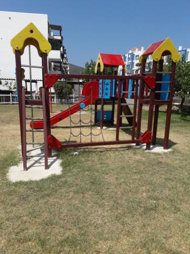 a playground with a slide in a park at Studio avec piscine à Mirador cabo négro in Cabo Negro