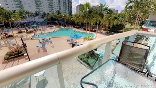 a view of a swimming pool from a balcony at Sunny Isles Condo Resort in Miami Beach