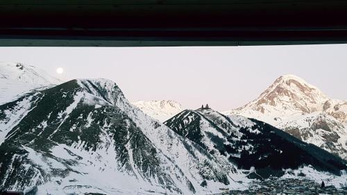 a view of a snow covered mountain range at Rustaveli st11 in Stepantsminda