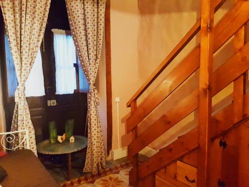a room with a staircase with a table and a window at B&B La Laguna in La Laguna