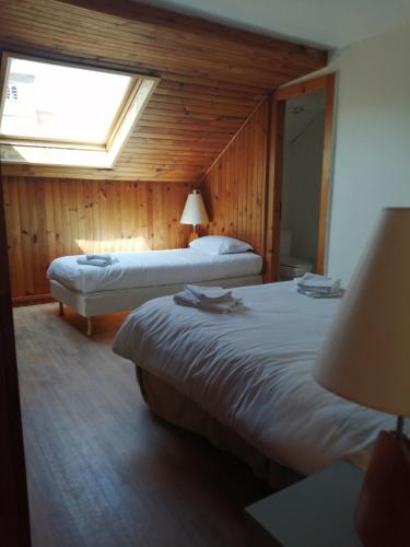 une chambre d'hôtel avec deux lits et une fenêtre dans l'établissement Mamyvonne Vacances, à Tendon