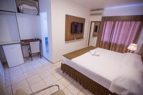 מיטה או מיטות בחדר ב-Hotel Vivere Cataratas